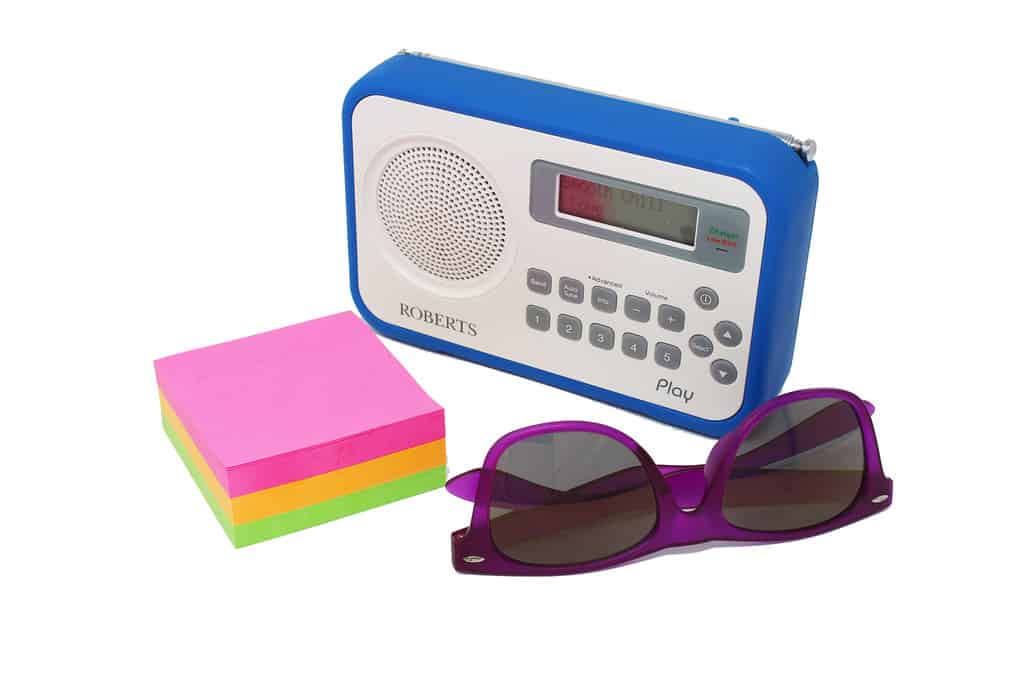 What is Shutter Speed in Photography? Perfectly exposed still life. Blue radio, coloured sticky notes, purple sunglasses.