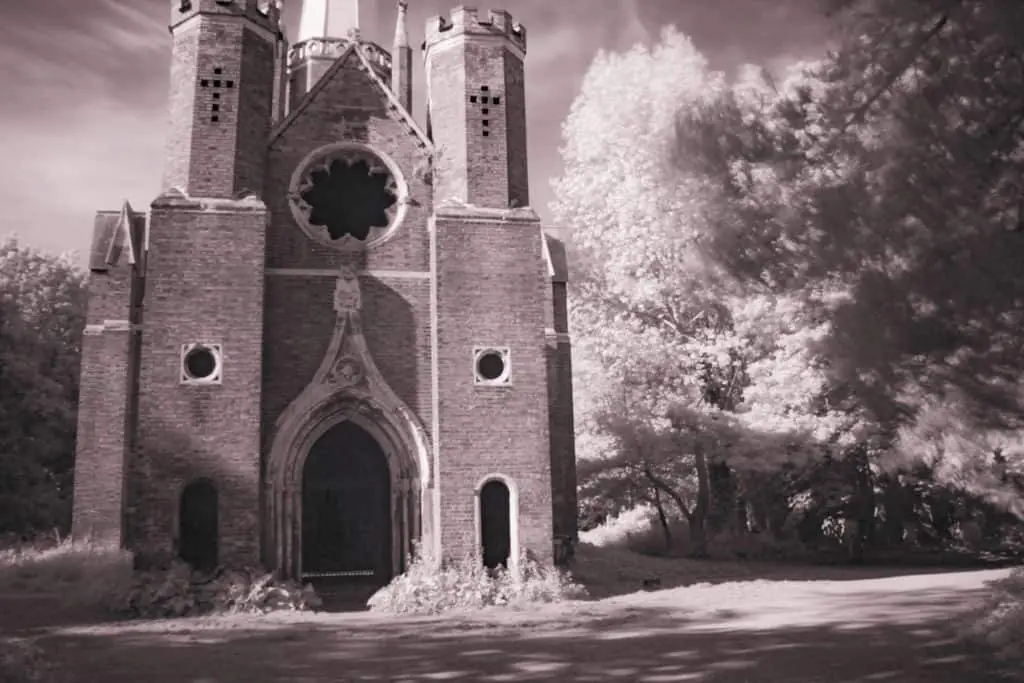 Infrared Photography With Filter on DSLR. Black and white infrared photo. Church in a wood.