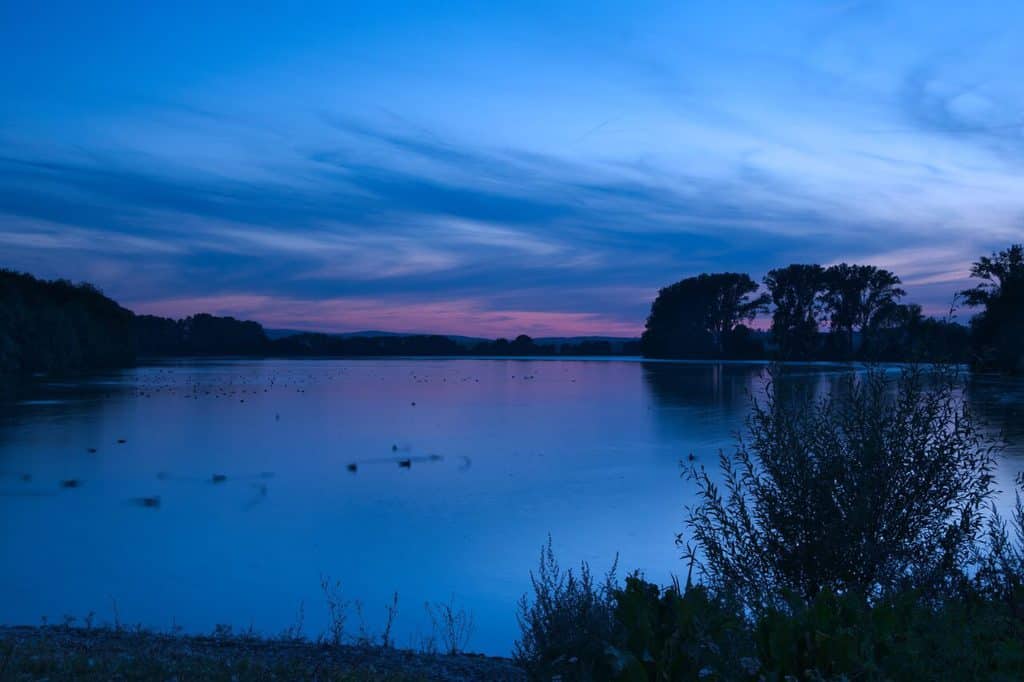 What is The Blue Hour in Photography? Lake and golden tinged sky.