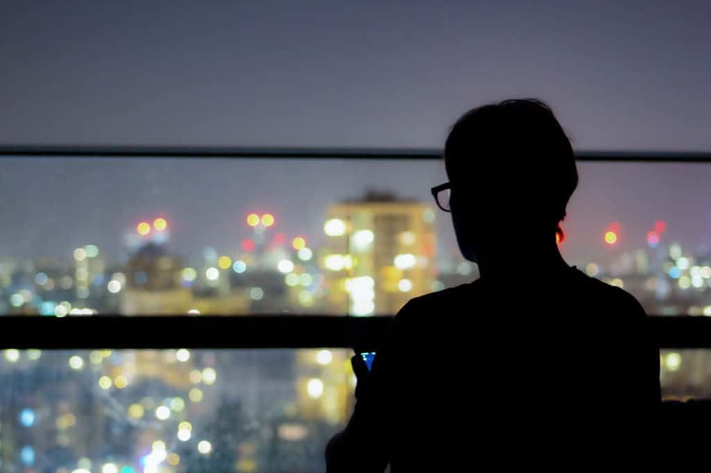 What is Bokeh in Photography? Silhouette against a nighttime cityscape.