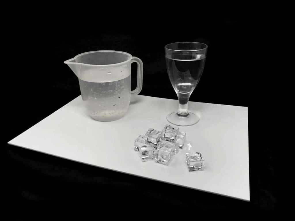 Ice Cube Splash Photography. Required props, plexiglas, glass, water, acrylic ice cubes.