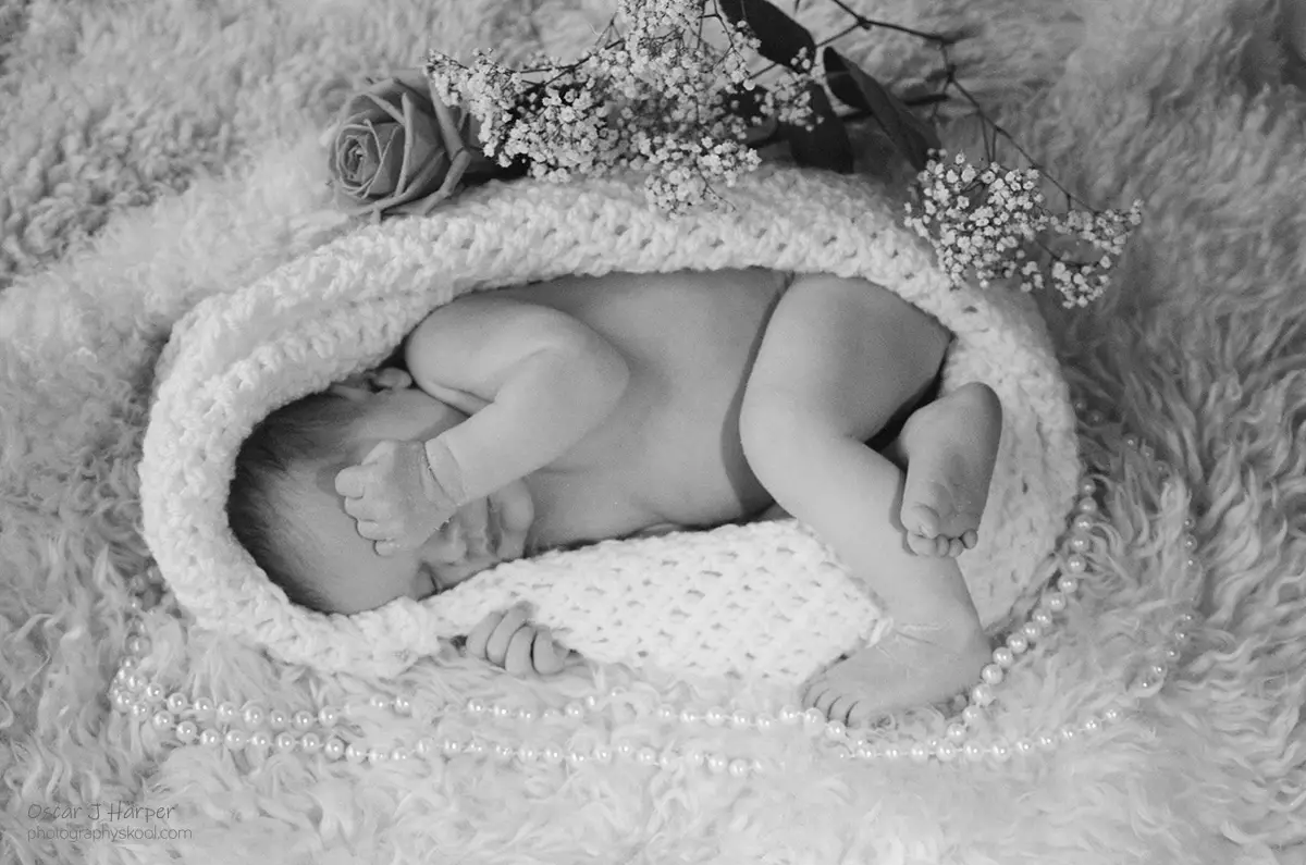 Best Time for Newborn Photos! Open wrap pose with flowers and accessories.